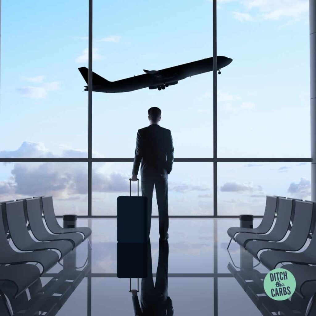a man watching a plane at the airport