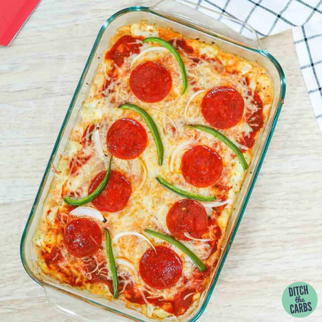 Keto pizza casserole cooling on the counter after baking.